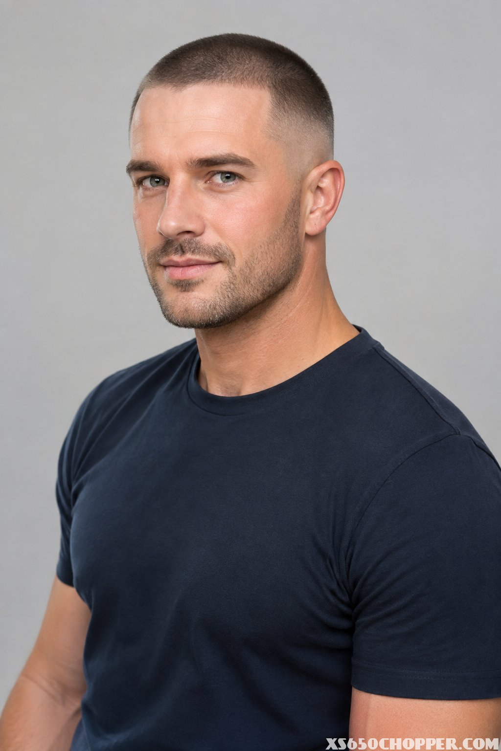 A man with a short buzz cut and skin fade haircut.
