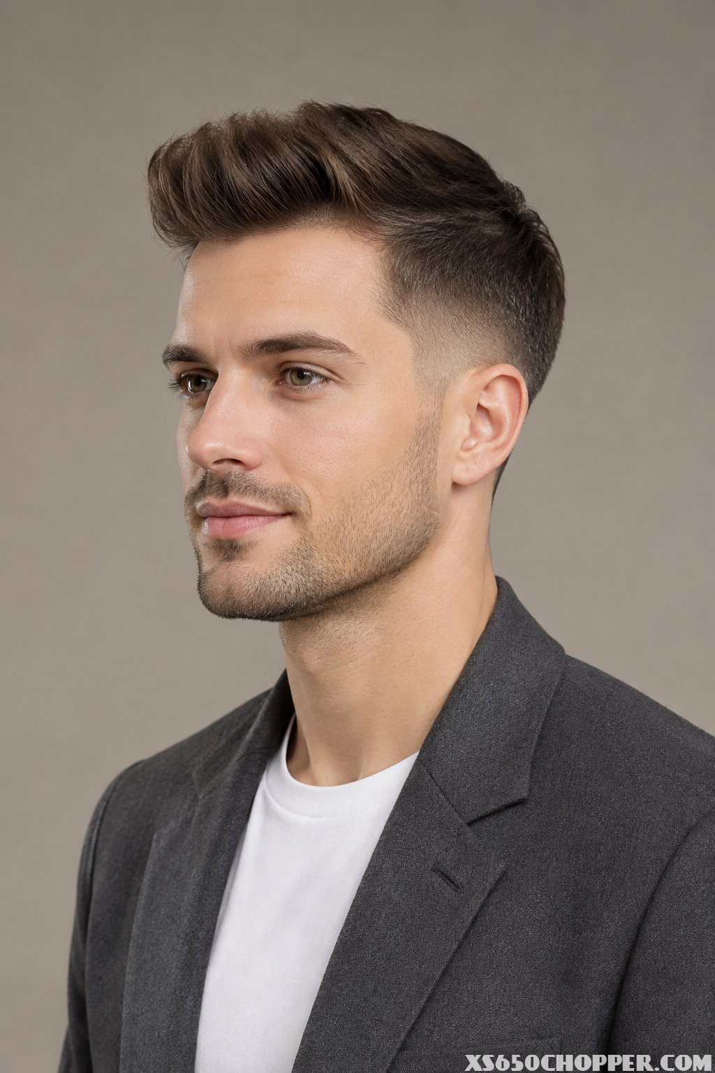A man with fine hair styled in a short pompadour and tapered sides.