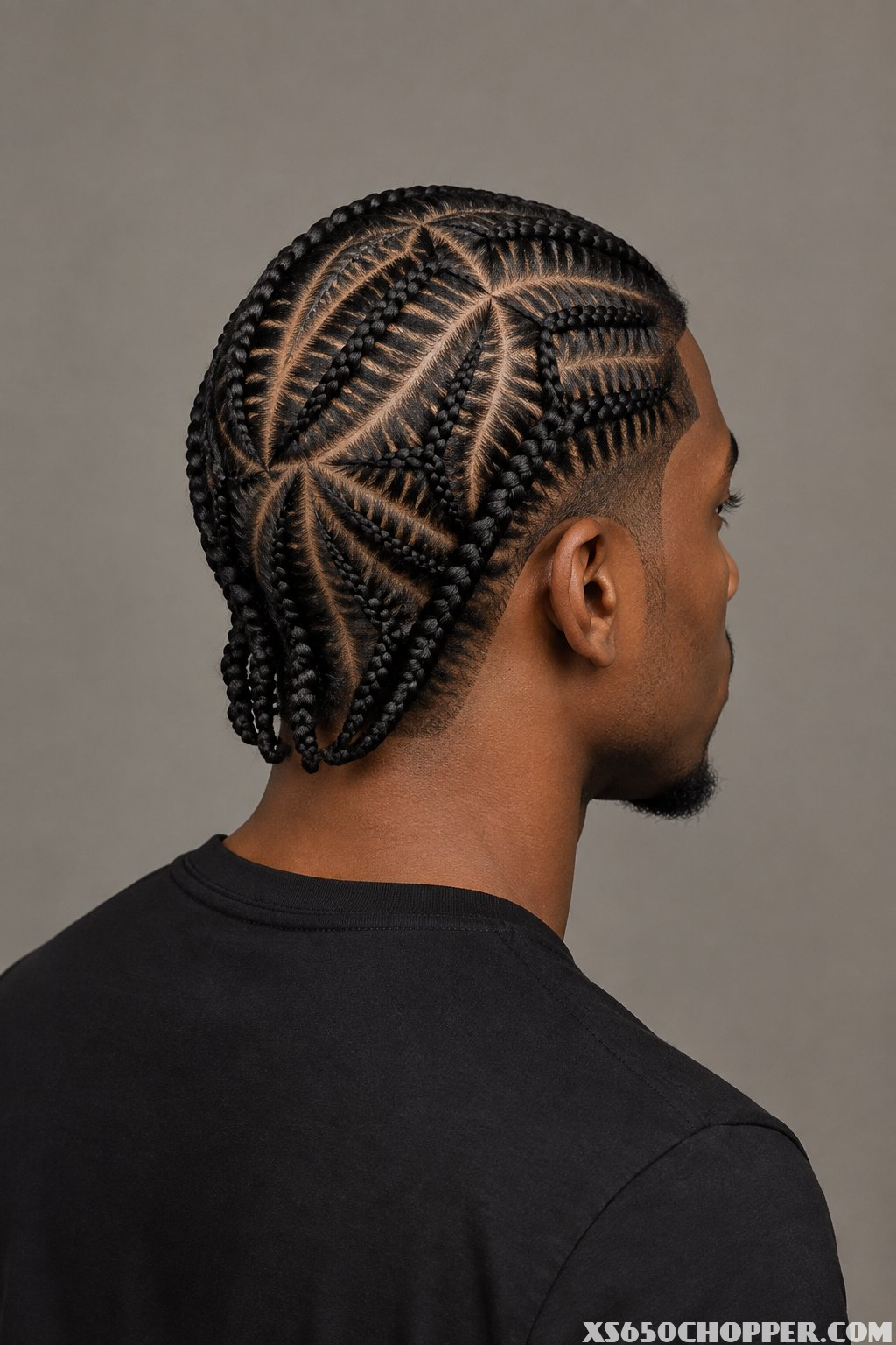 Man with geometric cornrows and a sharply edged hairline.