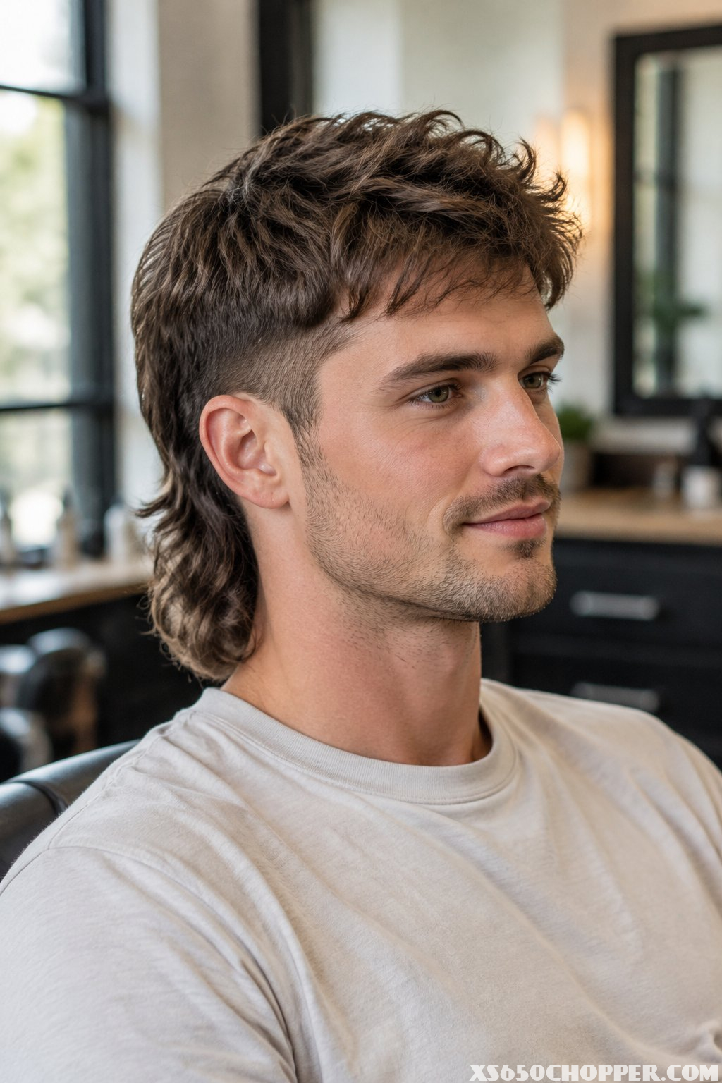 A man sits in a barbershop.