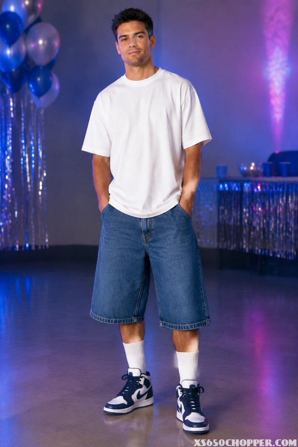 A man wearing long denim shorts, tall socks, and high-top sneakers.