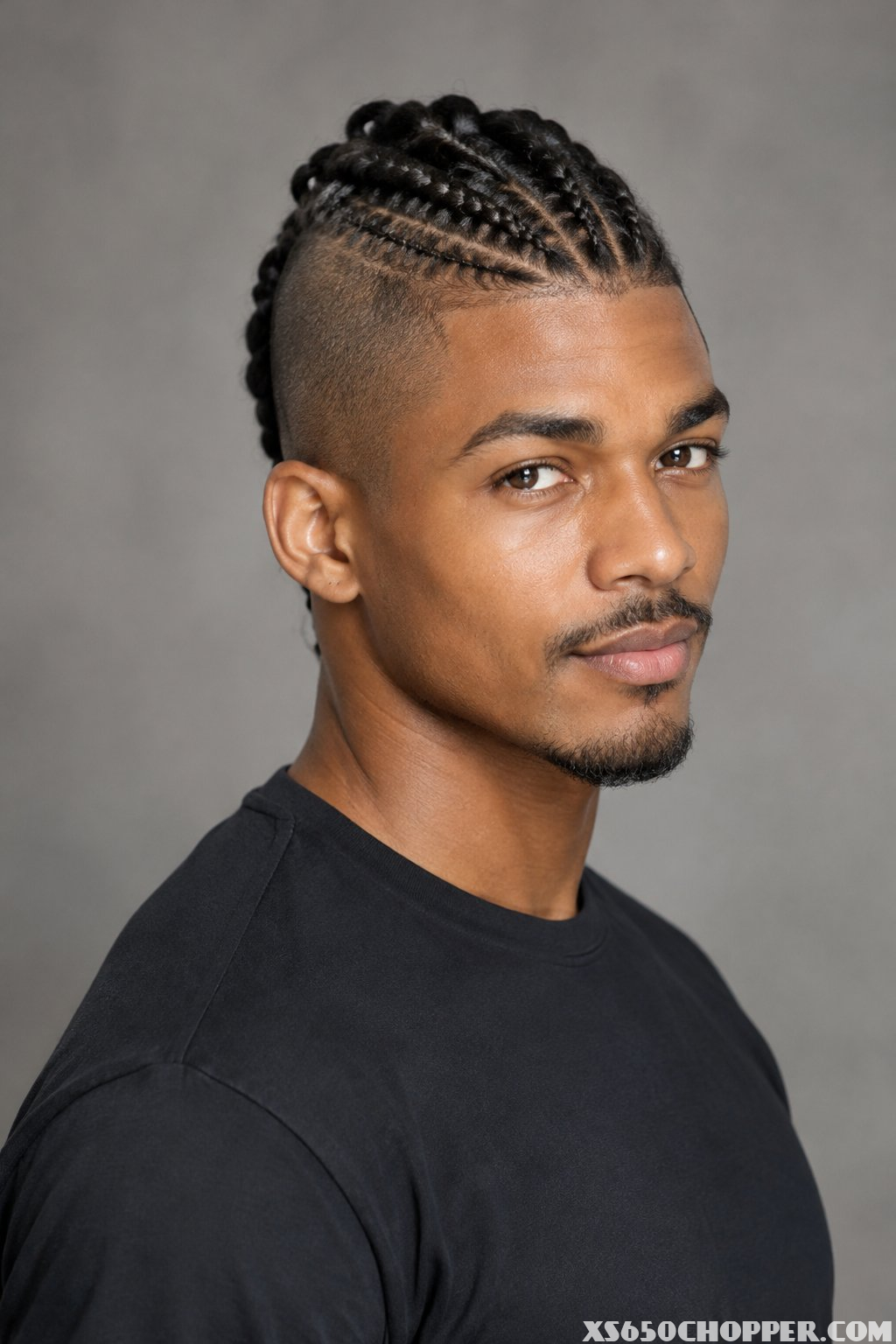 A man posing against a plain background.