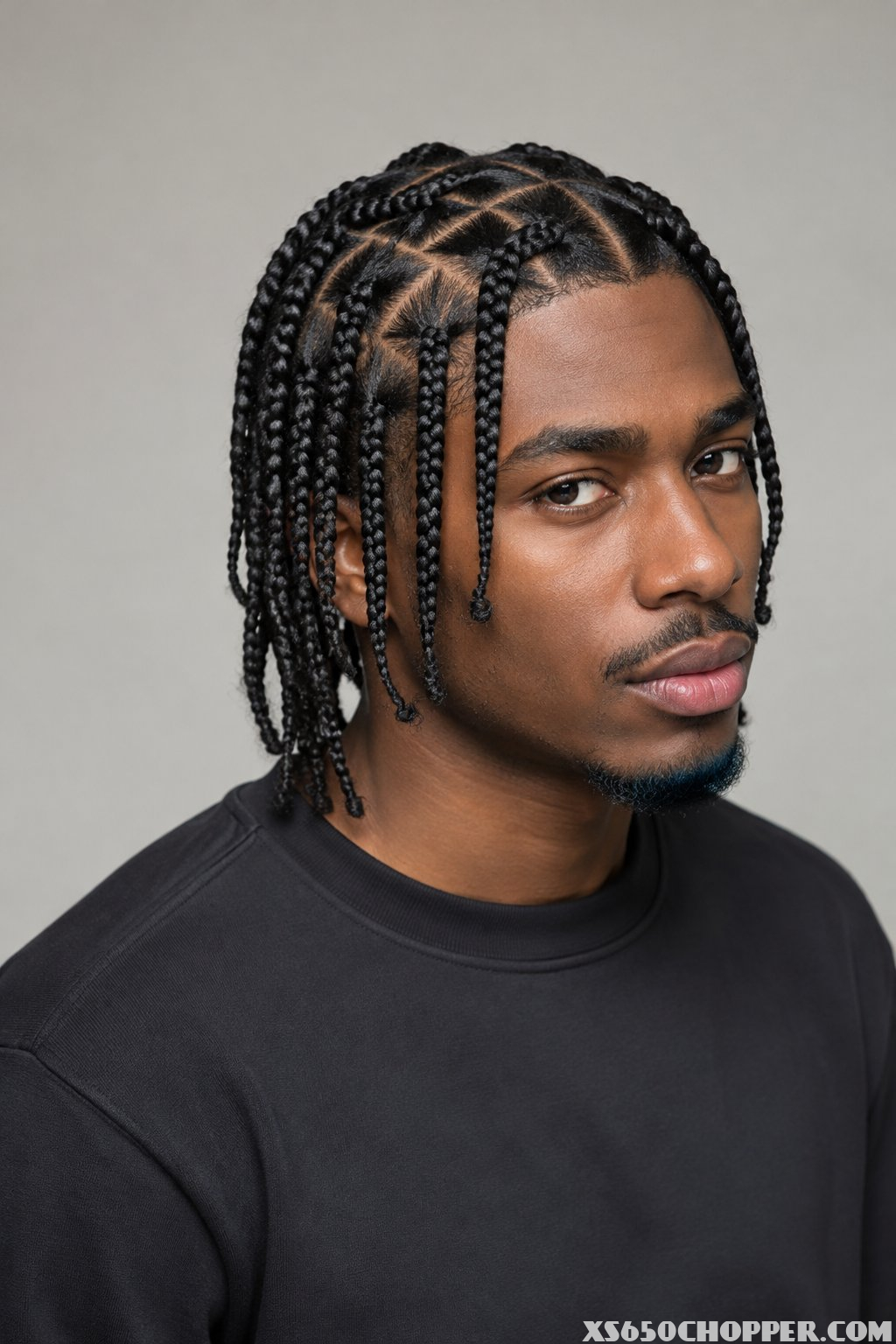 A man poses against a plain background.