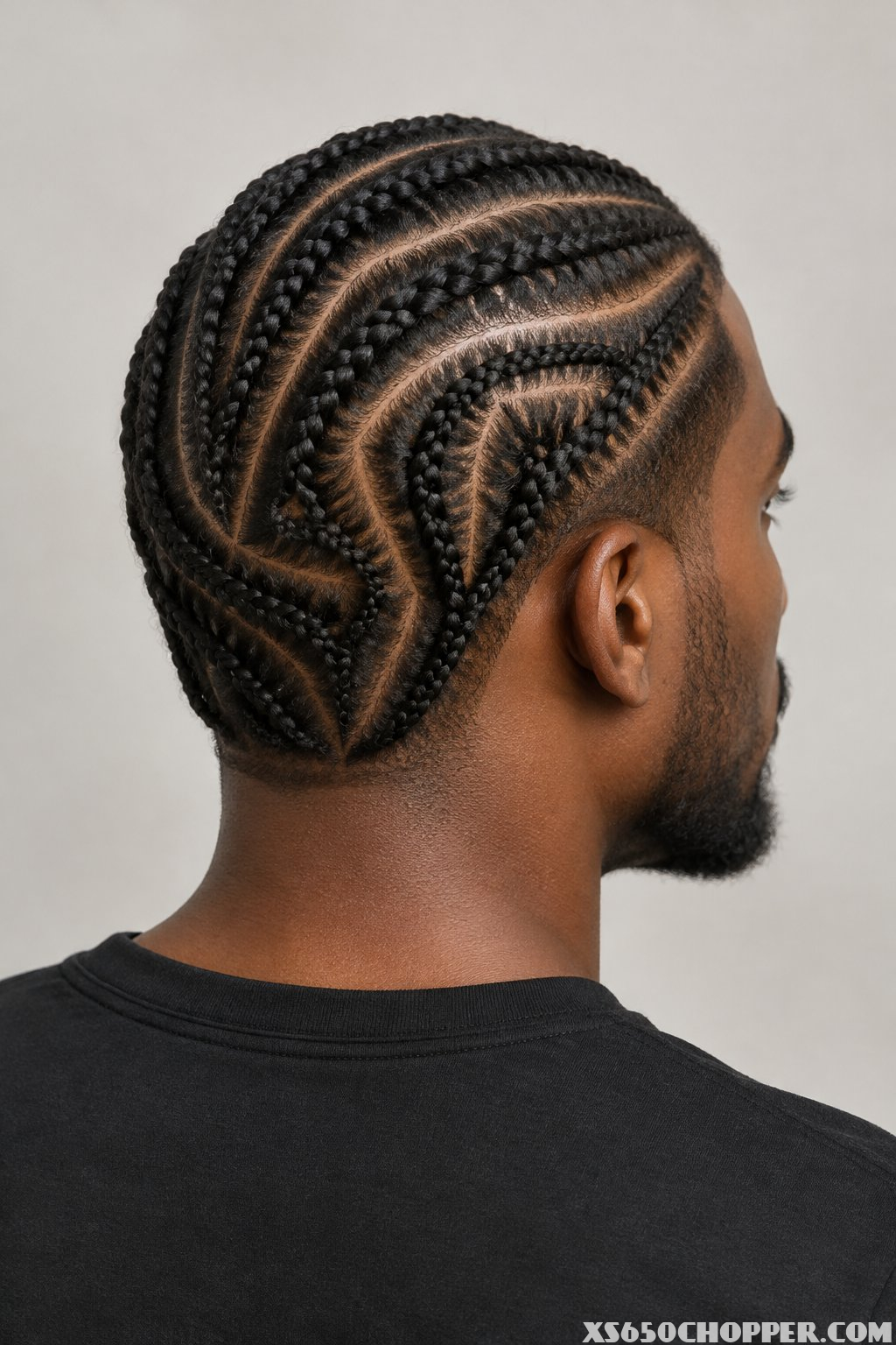 A man with short braided hair.