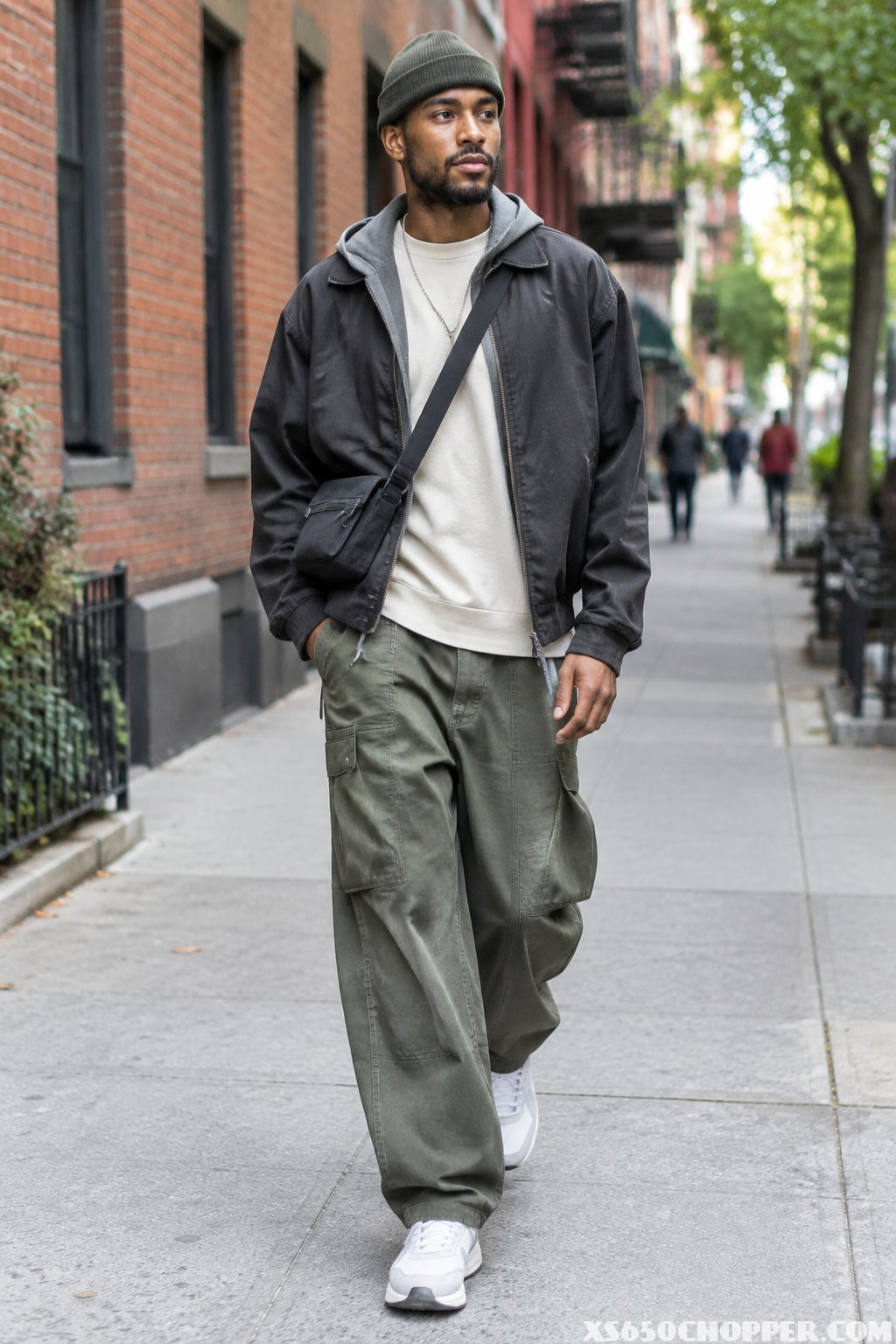 A man walks along a city sidewalk.