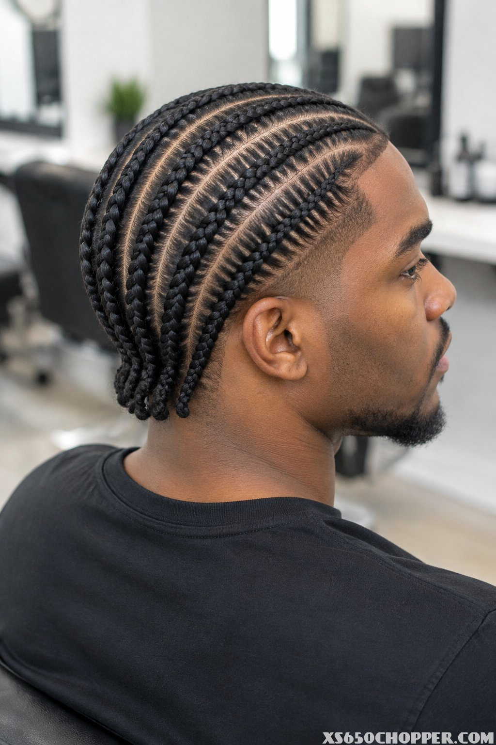 A man sitting in a barbershop.