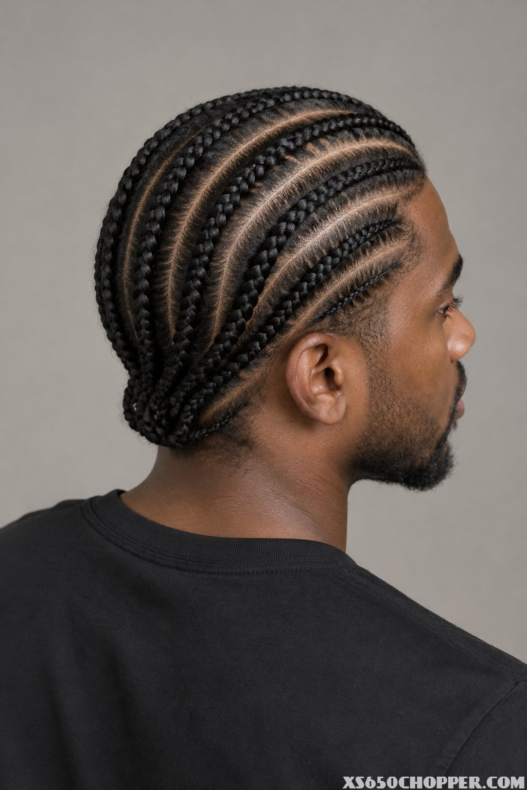 A man seen from behind with his head turned slightly to the side.