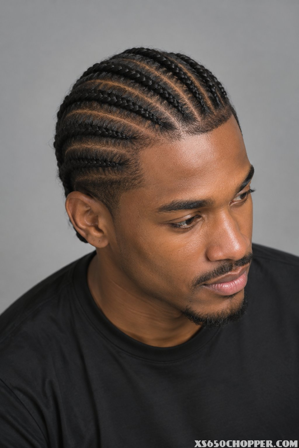 A man poses against a plain background.