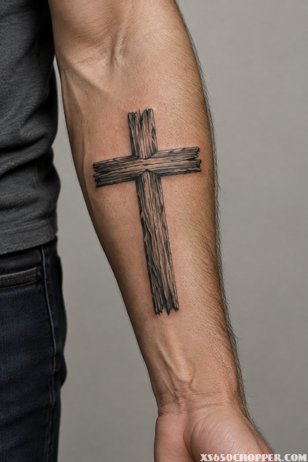 A wood-grain cross tattoo on a man's forearm.